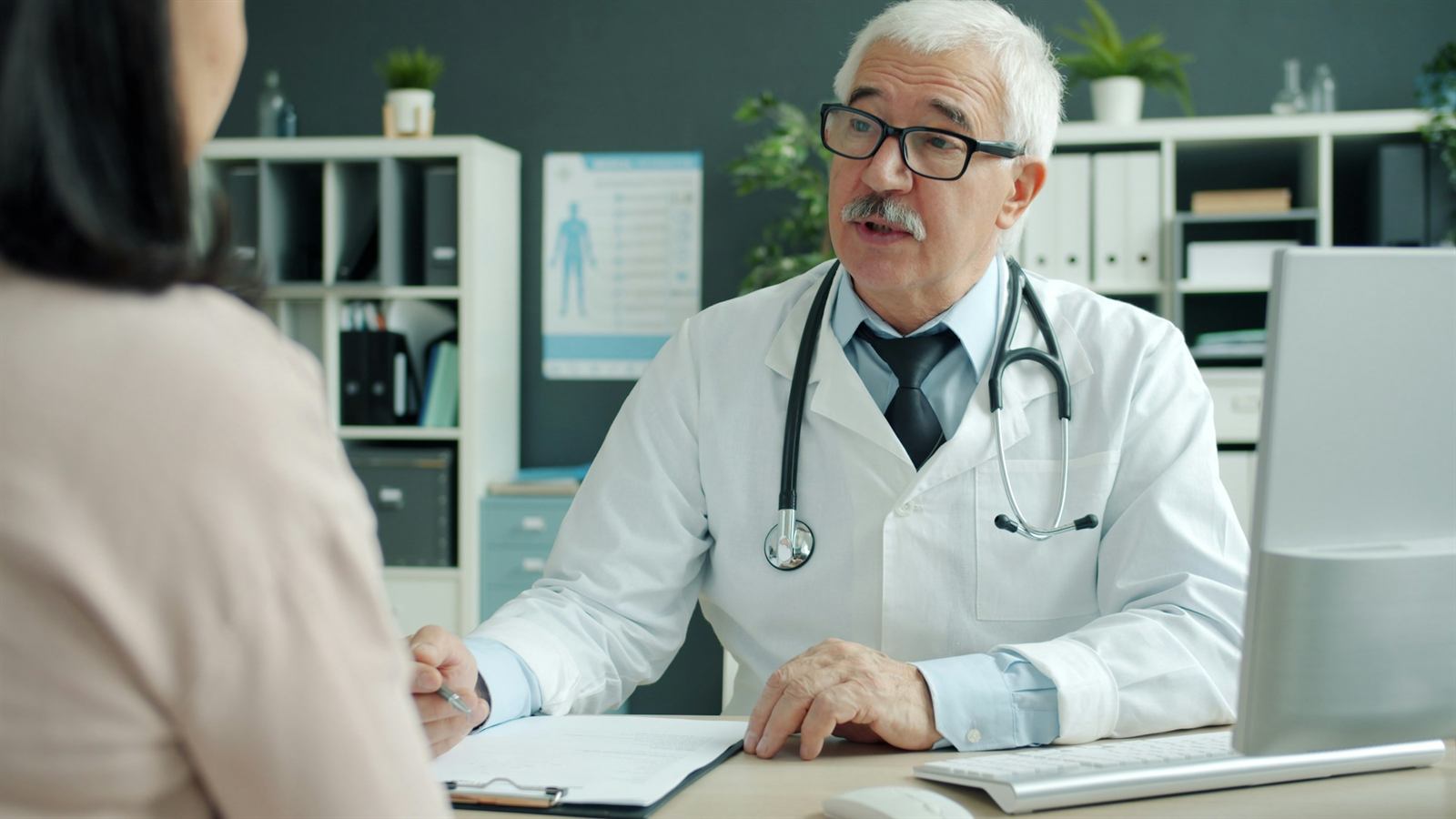 Doctor talking with a patient in an exam room